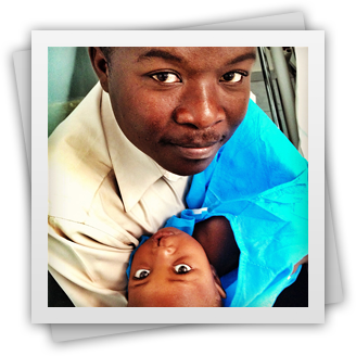 Man holding his child with a cleft diformity